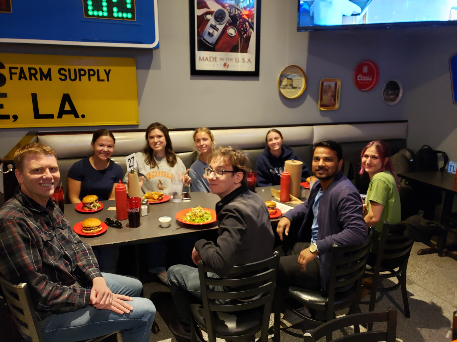 Photograph of Reed, Reagan, Claire, Addison, Landry, Alex, Mehraj, and Paul at the Garage eating lunch.