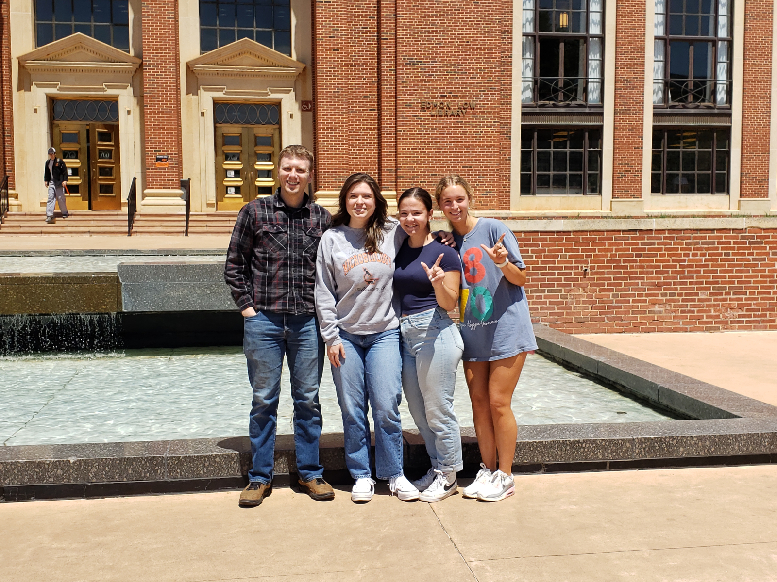 Reed, Claire, Reagan, and Addison in front of Edmon Low Library