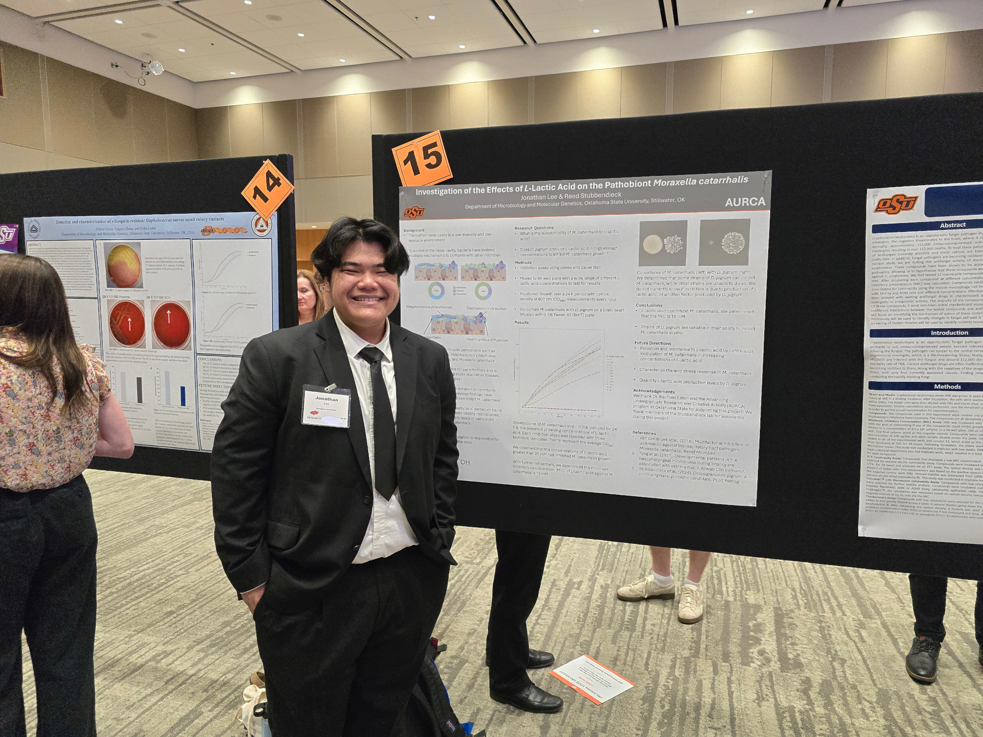 Photograph of Jonathan presenting his poster at the Undergraduate Research Symposium.