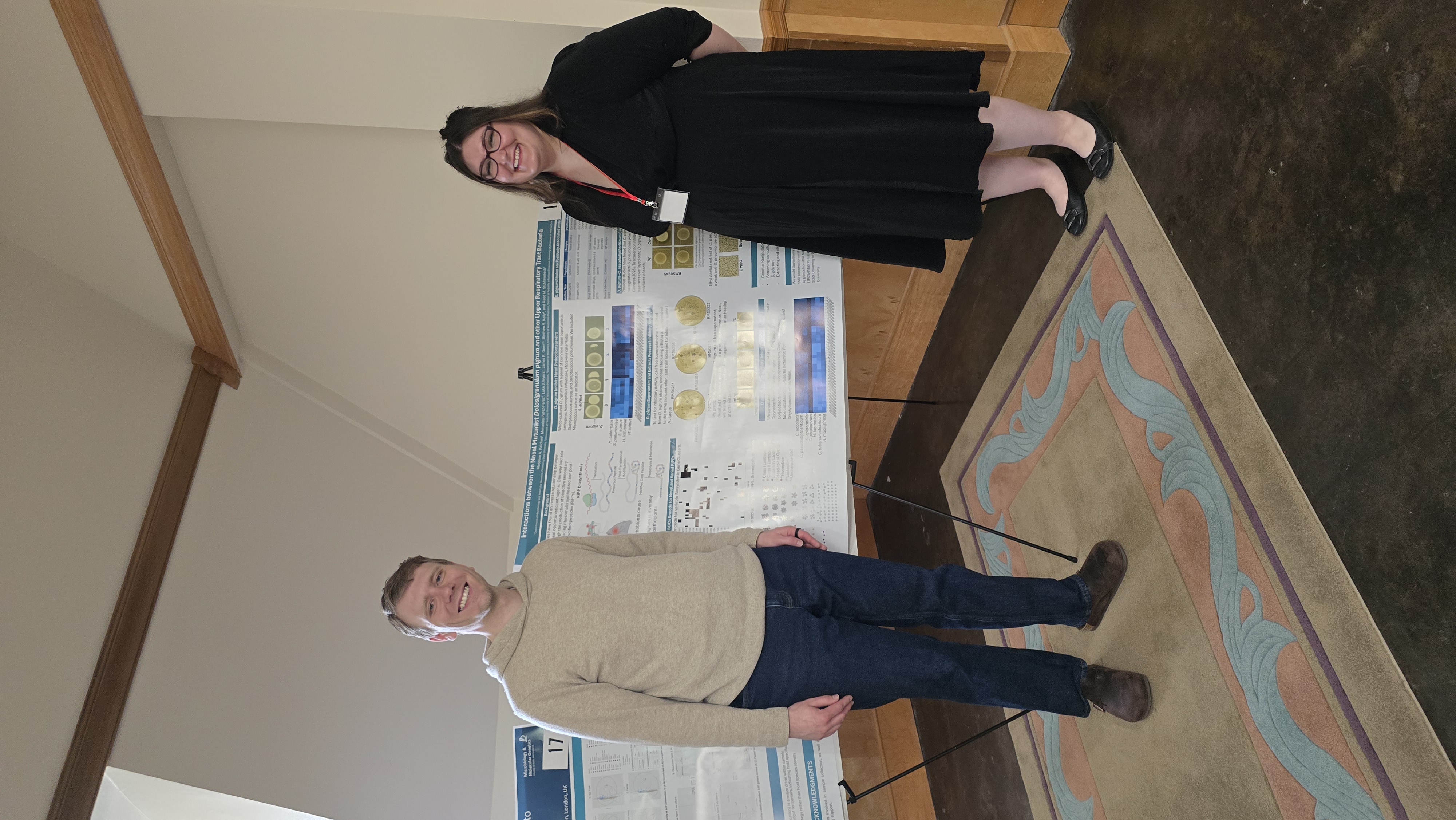 Madeline and Reed in front of Madeline's poster at the Microbiology and Molecular Genetics Research Symposium
